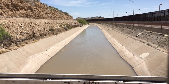 The Rio Grande is channeled through an artificial canal in El Paso. It looks calm on the surface but is too deep to walk through and very swift.