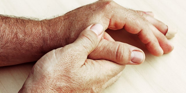 An elderly man has pain in fingers and hands