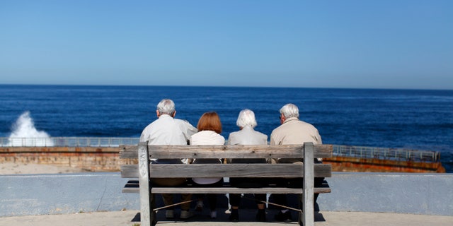 A pair of elderly couples view the ocean and waves along the beach in La Jolla, California March 8, 2012. (REUTERS/Mike Blake)
