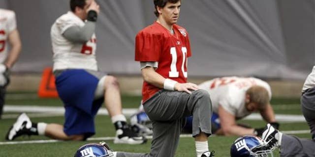 New York Giants quarterback Eli Manning (10) stretches during practice for the NFL Super Bowl XLVI in Indianapolis February 2, 2012. The New York Giants will play the New England Patriots on February 5. REUTERS/Jeff Haynes