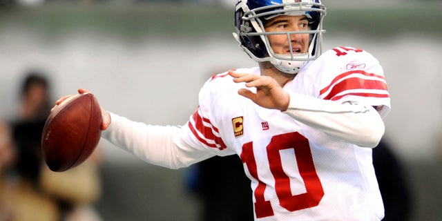 In this Dec. 24, 2011, file photo, New York Giants quarterback Eli Manning looks to pass during the second quarter of an NFL football game against the New York Jets, in East Rutherford, N.J.