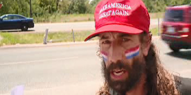 Elliot Timms has been running nearly every day for a year holding an American flag.