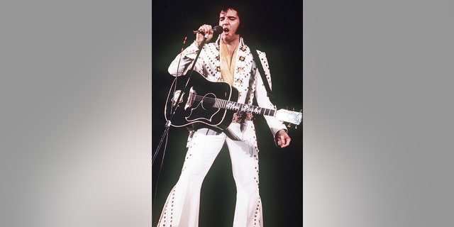 In this 1973 file photo, Elvis Presley sings during a concert. Friends and fans of late singer and actor Elvis Presley are descending on Memphis, Tenn., for Elvis Week, the annual celebration of his life and career. It coincides with the 40th anniversary of the passing of Presley, who died on Aug. 16, 1977. (AP Photo, File)