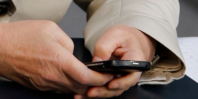 FILE: UNDATED: A person sends an email on a smartphone.
