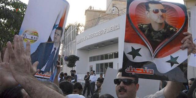 Friday: Pro-Syrian President Bashar Assad protesters gather in front the U.S. Embassy in Damascus.