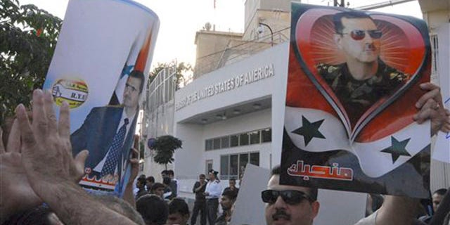 Friday: Pro-Syrian President Bashar Assad protesters gather in front the U.S. Embassy in Damascus.