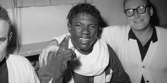 In this June 8, 1963 file photo, Emile Griffith smiles in the dressing room after regaining his welterweight world championship title by defeating Luis Rodriguez, at New York’s Madison Square Garden.