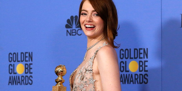 Emma Stone poses with her award for Best Performance by an Actress in a Motion Picture - Musical or Comedy for her role in "La La Land" during the 74th Annual Golden Globe Awards