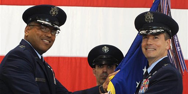 In this photo provided by the U.S. Air Force, Brig. Gen. Paul W. Tibbets IV, right, receives the the 509th Bomb Wing guidon from Air Force Maj. Gen. Richard Clark, left, to take over leadership of the United States' aging fleet of nuclear-capable B-2 stealth bombers at Whiteman Air Force Base, Mo.