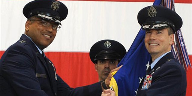 In this photo provided by the U.S. Air Force, Brig. Gen. Paul W. Tibbets IV, right, receives the the 509th Bomb Wing guidon from Air Force Maj. Gen. Richard Clark, left, to take over leadership of the United States' aging fleet of nuclear-capable B-2 stealth bombers at Whiteman Air Force Base, Mo.
