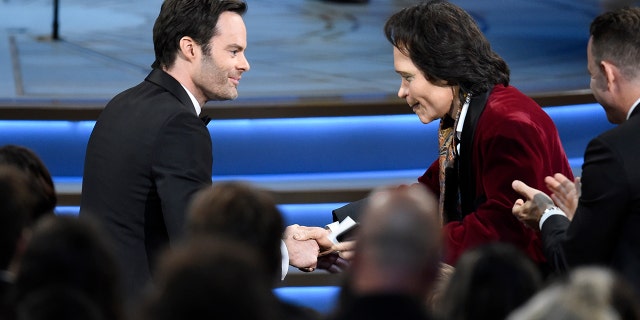 Teddy Perkins, right, congratulates Bill Hader as he gets ready to walk on stage to accept the award for outstanding lead actor in a comedy series for "Barry" at the 70th Primetime Emmy Awards.