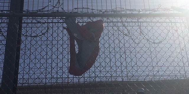 A vest in barbed wire used to protect immigrants from cuts as they jump. Rodriguez says she's watched many people illegally cross, and has a video of two in her backyard.
