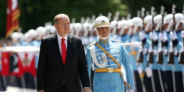 Turkey's President Recep Tayyip Erdogan inspects an honour guard as he arrives at the parliament in Ankara, Turkey to attend opening session of the new parliament in Ankara, Turkey, Saturday, July 7, 2018.