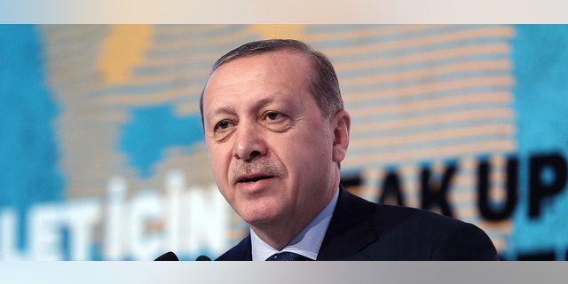 Turkey's President Recep Tayyip Erdogan addresses a meeting about "Women and Justice" in Istanbul, Friday, Nov. 25, 2016. Erdogan on Friday accused the European Union of dishonesty and betrayal, and threatened to remove controls from his country's borders, flooding Europe with hundreds of thousands of asylum-seekers and other migrants. (Murat Cetinmuhurdar/Presidential Press Service, Pool photo via AP)