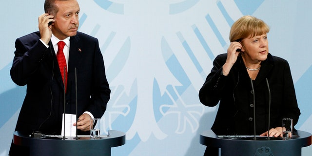Oct. 31, 2012: German Chancellor Angela Merkel, right, and Turkey's President Recep Tayyip Erdogan, left, address the media during a joint press conference after a meeting at the chancellery in Berlin, Germany.