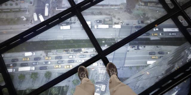 A view through the Sky Portal shows a live video view of the streets below from One World Observatory, Wednesday, May 20, 2015, in New York. The observatory atop the 104-story One World Trade Center opens to the public on May 29. (AP Photo/Mark Lennihan)