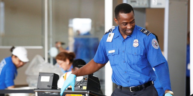TSA officer at security checkpoint.
