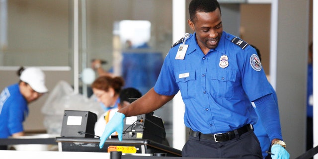 TSA officer at security checkpoint.