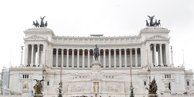 The droopy-branched tree stands in the center of the city at Piazza Venezia.