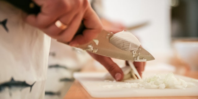 Cooking Classes Instructor showing How Cutting onion