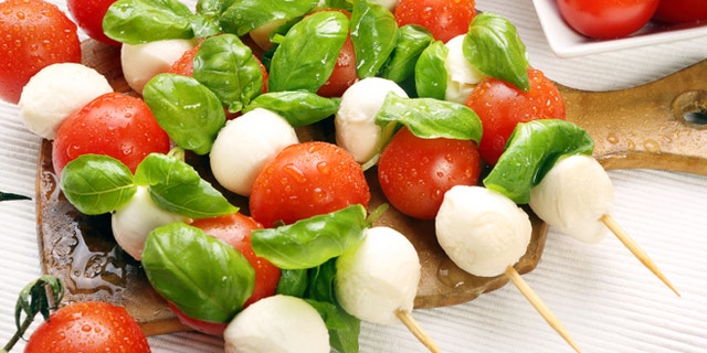 Caprese salad. Skewers with tomato and mozzarella with basil