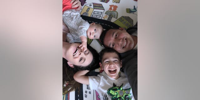 Clockwise from top: Eric, Jake, Taylor, and Eric and Taylor's 8-month old daughter pose for a photo.