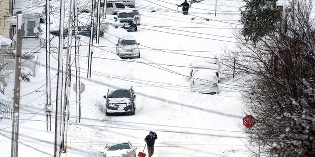 Erie, Pa., residents dig out on Tuesday, Dec. 26, 2017, after an unprecedented two-day snowfall. The National Weather Service office in Cleveland says the storm brough 34 inches on Christmas Day, a new all-time daily snowfall record for Erie.