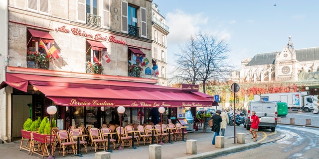 Paris/France - October 5, 2009: Restaurant "Au chien qui fume" (The dog who smokes) in rue du Pont Neuf. In the background the Saint Eustache church.
