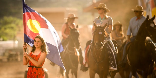 Maebellene Burge carried the Colorado flag during the grand entry for the fourth COS Rodeo of the summer Wednesday, July 6, 2016 at the Norris-Penrose Event Center. The event resumes for four consecutive Wednesday nights at 5pm beginning July 27th. Tickets art $34 and include dinner, rodeo and a concert. Visitors can even participate in certain selected events. Photo by Mark Reis, The Gazette