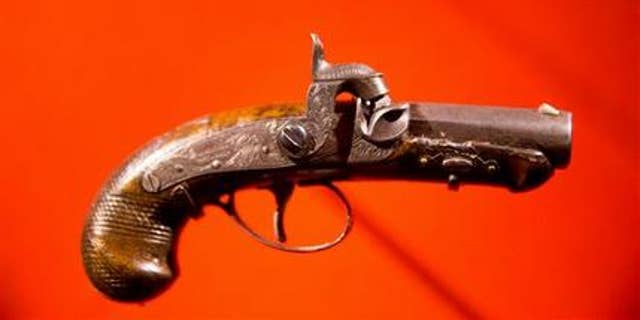 In this March 17, 2015, file photo, John Wilkes Booth's pistol used to kill President Abraham Lincoln is displayed at a new exhibit at the Ford's Center for Education and Leadership.