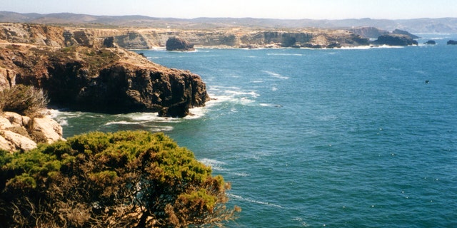 The portugal coastline at the Parque Natural do Sudoeste Alentejano e Costa Vicentina, near Cabo de São Vicente, a headland in the municipality of Sagres, Algarve, southern Portugal. This cape is the southwesternmost point in Portugal The cliffs rise nearly vertically from the Atlantic to a height of 75 meters.