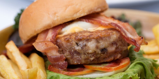 hamburger beef bacon egg french fries and salad