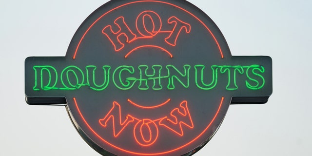 Huntsville, Alabama, USA - July 17, 2011: Close up of illuminated neon Hot Doughnuts Now sign at Krispy Kreme store. Sign located on North Memorial Parkway near Cook Avenue in Huntsville, Alabama.