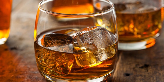 Alcoholic Amber Whiskey Bourbon in a Glass with Ice