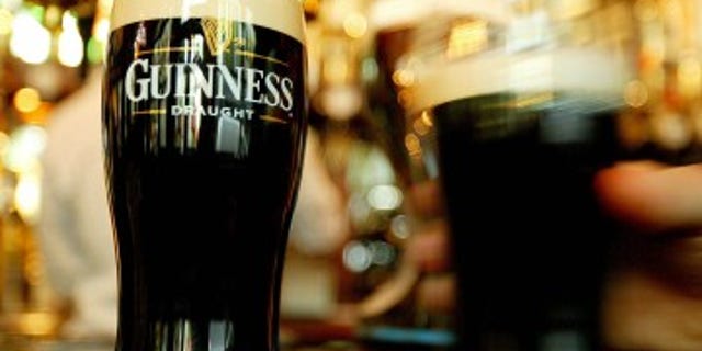 Pints of Guinness are seen in a London pub, March 1, 2004. The secret "essence of Guinness" has been the subject of more intense speculation than of any other beer in the history of brewing. The company publicly acknowledges that barley, water, hops and yeast are all used in the process of concocting Ireland's distinctive black creamy stout. REUTERS/Peter Macdiarmid TO ACCOMPANY FEATURE BC-IRELAND-GUINNESS PKM/MD/CRB