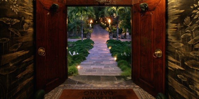 Decadent doors welcome guests inside.