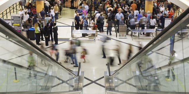 Airline travelers move through a TSA line at Atlanta's Hartsfield-Jackson International Airport.