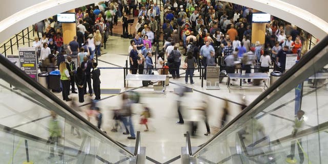 Airline travelers move through a TSA line at Atlanta's Hartsfield-Jackson International Airport.