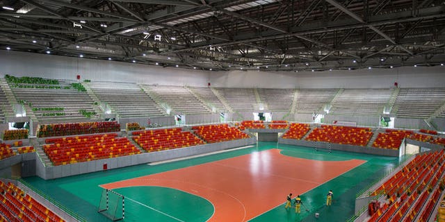 In this April 2016 file photo, workers clean the Future Arena, a temporary venue for Olympic handball this summer.