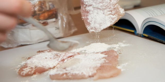dredging meat in flour, shallow DOF, close-up