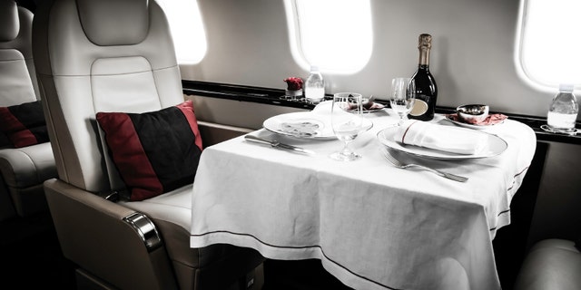 Luxury Business Jet Interior with served table and leather chair