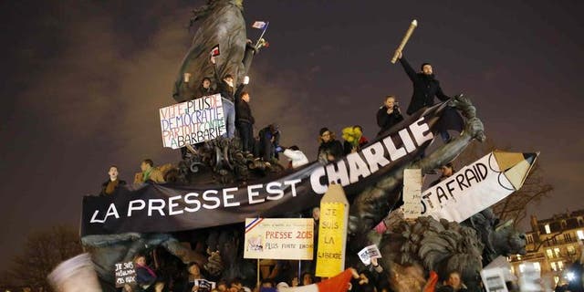 Hundreds of thousands of people marched through Paris on Sunday in a massive show of unity and defiance in the face of terrorism that killed 17 people in France's bleakest moment in half a century