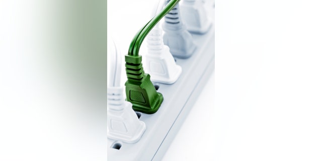 Many plugs plugged into electric power bar
