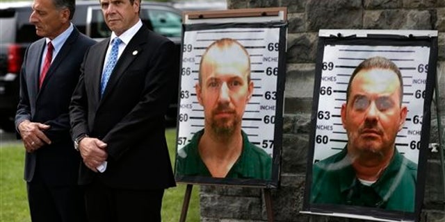 FILE - In this June 10, 2015 file photo, Vermont Governor Peter Shumlin, left, and New York Governor Andrew Cuomo listen during a news conference in front of the Clinton Correctional Facility in Dannemora, N.Y., where David Sweat and Richard Matt, escaped using power tools. As the hunt for the two escaped killers in New York stretches to almost a week, a review of past high-profile escapes shows most do in fact get caught sooner or later, tripped up by any number of missteps or miscalculations. (AP Photo/Seth Wenig, File)