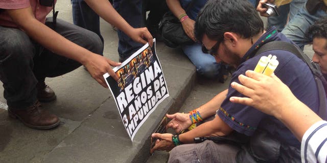 Ruben Espinosa on April 28, 2015, placing a plaque to rename a plaza after slain journalist Regina Martinez.