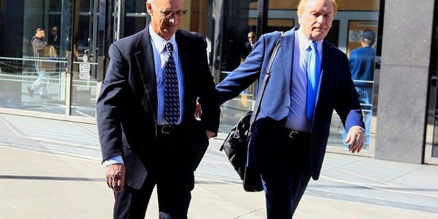 March 8, 2012: Robert Maegerle, left, walks out of a federal courthouse with attorney Jerome Froelich Jr. in San Francisco.
