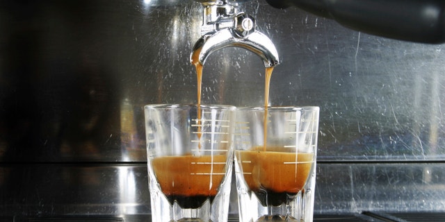 Espresso being drawn out of a professional espresso machine