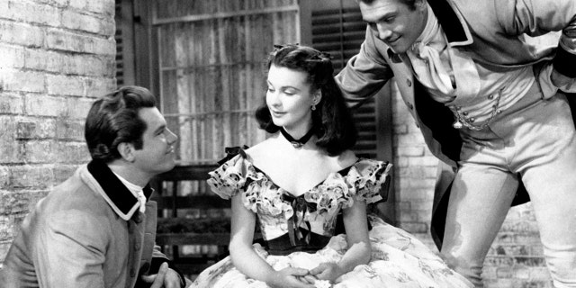 From the left american actors Fred Crane and George Reeves, as Brent and Stuart Tarleton respectively in "Gone with the Wind "by Victor Fleming, court British actress Vivien Leigh, as Scarlett O'Hara, in a scene from the movie. USA, 1939. (Photo by Mondadori Portfolio via Getty Images)