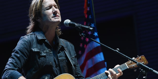 Keith Urban performs 'Bridge Over Troubled Water' during Nashville Candelight Vigil For Las Vegas at Ascend Amphitheater on October 2, 2017 in Nashville, Tennessee.
