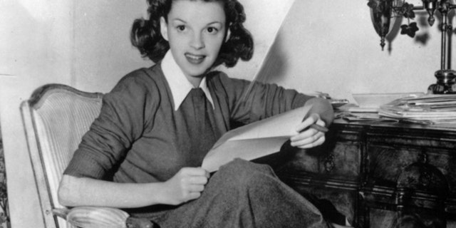 Judy Garland checking fanmail at her home.